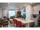 Bright, open-concept living space featuring kitchen island seating and inviting living area at 5126 Buckwheat Rd, Brighton, CO 80640