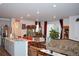 Open concept living area featuring a kitchen island, dining area, and comfortable living space at 5126 Buckwheat Rd, Brighton, CO 80640