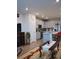 Open-concept living area with stainless steel appliances, a breakfast bar, and hardwood flooring at 5126 Buckwheat Rd, Brighton, CO 80640