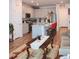 Open-concept living area with stainless steel appliances, a breakfast bar, and hardwood flooring at 5126 Buckwheat Rd, Brighton, CO 80640