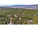 High aerial shot of homes nestled in a lush green forest with mountain views at 20050 Lost Arrowhead Dr, Monument, CO 80132