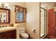 Bathroom featuring a wooden vanity, tiled shower, and wood accents at 20050 Lost Arrowhead Dr, Monument, CO 80132
