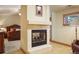 Bright bedroom featuring a cozy fireplace, plush carpet and a picture window with natural light at 20050 Lost Arrowhead Dr, Monument, CO 80132