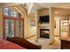 Bright bedroom featuring a cozy fireplace, plush carpet and a picture window with a scenic view at 20050 Lost Arrowhead Dr, Monument, CO 80132