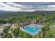 An aerial view of a community pool area surrounded by trees and buildings at 20050 Lost Arrowhead Dr, Monument, CO 80132