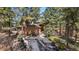 Exterior of home featuring a three-car garage and lush landscaping at 20050 Lost Arrowhead Dr, Monument, CO 80132