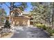 Attractive two-story home with a three-car garage and attractive mature trees surrounding the property at 20050 Lost Arrowhead Dr, Monument, CO 80132