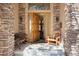 Inviting front porch featuring stone columns and an open door at 20050 Lost Arrowhead Dr, Monument, CO 80132