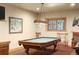 Game room with pool table, light fixture, and an adjacent seating area at 20050 Lost Arrowhead Dr, Monument, CO 80132