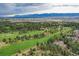 Aerial view of a golf course with mountain views in the distance at 20050 Lost Arrowhead Dr, Monument, CO 80132