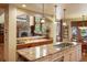 Well-appointed kitchen with a granite-topped island cooktop, tile backsplash and eat-in area at 20050 Lost Arrowhead Dr, Monument, CO 80132