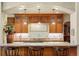 Kitchen featuring a breakfast bar, granite countertops, tile backsplash, and wood cabinets at 20050 Lost Arrowhead Dr, Monument, CO 80132