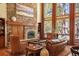 Living room featuring a stone fireplace, hardwood floors, and an open layout at 20050 Lost Arrowhead Dr, Monument, CO 80132