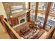 Stunning living room features a stone fireplace, wood floors, and large windows with natural light at 20050 Lost Arrowhead Dr, Monument, CO 80132