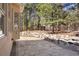 Stone patio with rock wall and view of trees in backyard at 20050 Lost Arrowhead Dr, Monument, CO 80132