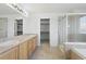 Bathroom with double sink vanity, tiled floor, glass shower door, and walk-in closet at 134 Laramie Ct, Castle Rock, CO 80104
