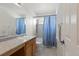 Well-lit bathroom features a shower-tub combo, vanity with sink, and tiled floor at 134 Laramie Ct, Castle Rock, CO 80104