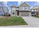 Charming two-story home with a well-manicured lawn and attached two-car garage at 134 Laramie Ct, Castle Rock, CO 80104
