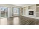 Bright living room featuring dark wood floors, neutral walls, built-in shelves, and a fireplace at 134 Laramie Ct, Castle Rock, CO 80104