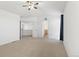 Bright primary bedroom featuring neutral walls, ceiling fan, ensuite bathroom, and walk-in closet at 134 Laramie Ct, Castle Rock, CO 80104