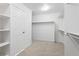 A large walk-in closet with carpeted floors, white walls, and storage shelving at 134 Laramie Ct, Castle Rock, CO 80104