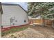 House featuring a small wooden deck, nice tree and space for Gathering and friends to enjoy at 7661 Gray Way, Arvada, CO 80003