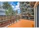 Outdoor deck surrounded by mature trees and shrubs provides a quiet outdoor space at 7661 Gray Way, Arvada, CO 80003