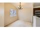 Dining room features a large window and a modern chandelier at 7661 Gray Way, Arvada, CO 80003