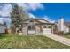 Charming single-Gathering home boasts a manicured lawn, brick accents, and an attached garage at 7661 Gray Way, Arvada, CO 80003