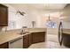 Cozy kitchen features stainless steel appliances, granite countertops, and tile floors at 7661 Gray Way, Arvada, CO 80003