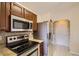 Cozy kitchen features stainless steel appliances, granite countertops, and tile floors at 7661 Gray Way, Arvada, CO 80003