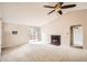 Bright living room features vaulted ceilings, neutral carpet, and sliding door access to a deck at 7661 Gray Way, Arvada, CO 80003