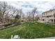 The backyard space has a green lawn and views of surrounding buildings and bare trees at 12480 W Nevada Pl # 214, Lakewood, CO 80228