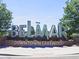 Belmar Downtown Lakewood neighborhood sign framed by lush trees under a clear blue sky at 12480 W Nevada Pl # 214, Lakewood, CO 80228