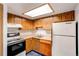 Functional kitchen equipped with appliances, wood cabinets, and ample counter space at 12480 W Nevada Pl # 214, Lakewood, CO 80228