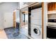 Convenient in-unit laundry closet with stacked washer and dryer, plus a fireplace at 12480 W Nevada Pl # 214, Lakewood, CO 80228