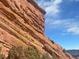 Dramatic view of Red Rocks Amphitheater's towering sandstone formations against a partly cloudy sky at 12480 W Nevada Pl # 214, Lakewood, CO 80228