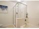 Bright bathroom featuring a shower over tub with glass enclosure and tiled walls at 1950 N Logan St # 102, Denver, CO 80203