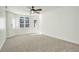 Bright bedroom with neutral carpet, bay window, and ceiling fan at 1950 N Logan St # 102, Denver, CO 80203