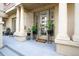 Elegant building entrance featuring stately columns and potted plants adorning the doorway at 1950 N Logan St # 102, Denver, CO 80203