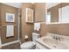 Bathroom featuring neutral walls, shower and bathtub, commode, and sink and vanity combo at 6827 Vivian St, Arvada, CO 80004