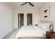 Cozy bedroom features soft carpet, neutral paint, ceiling fan, and closet with en suite bathroom at 3520 W Conejos Pl # 11, Denver, CO 80204