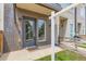 Close-up of a modern townhome's front door with brick facade, adjacent window, and a glimpse of the neighboring unit at 3520 W Conejos Pl # 11, Denver, CO 80204