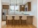 Beautiful kitchen with stainless steel appliances, island with seating, and contemporary pendant lighting at 3520 W Conejos Pl # 11, Denver, CO 80204