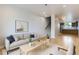 Bright living room with hardwood floors, modern furniture, and an open floor plan leading to the kitchen at 3520 W Conejos Pl # 11, Denver, CO 80204