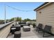 Relax on this beautiful rooftop deck featuring modern furniture and serene neighborhood views at 3520 W Conejos Pl # 11, Denver, CO 80204