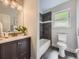 Updated bathroom featuring dark grey tile, modern fixtures, and a large window at 50 Yarrow St, Lakewood, CO 80226
