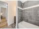 Modern bathroom with stylish grey tile and a tub and shower combo at 50 Yarrow St, Lakewood, CO 80226