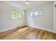 Empty bedroom with hardwood floors, two windows with natural light, and white walls ready to be styled at 50 Yarrow St, Lakewood, CO 80226