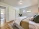 Bright bedroom featuring wood floors, white walls, closet and natural light from the window at 50 Yarrow St, Lakewood, CO 80226